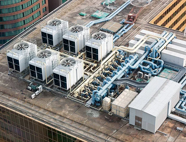 Commercial rooftop HVAC plant with chillers, fans and distribution piping